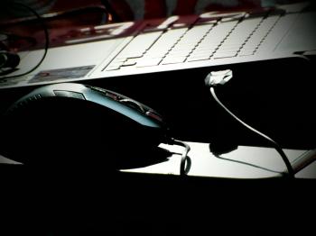Laptop and Mouse in Shadows
