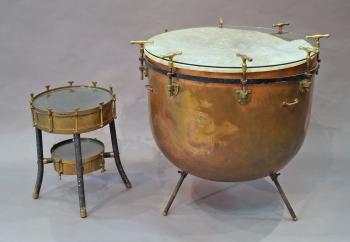A large copper kettle drum, converted to a table, stamped to the ...