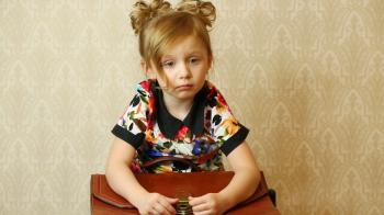 Little girl with pigtails sitting with a portfolio on the lap Stock ...