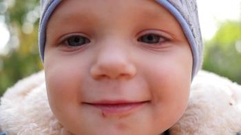 Little kid boy cute face closeup looking at camera without one front ...