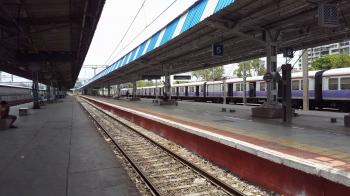 Empty railway station platform, long train, Mumbai slums, India ...