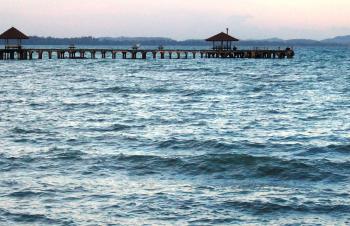 Long Wooden Tropical Pier at sunset