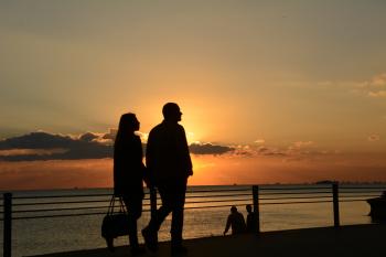 Man and Woman Silhouette Walking during Sunset