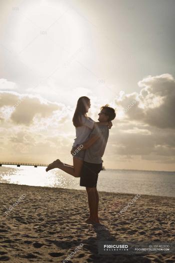 Man carrying woman at beach — Stock Photo | #151402830