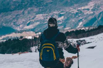 Man in Black and White Jacket and Blue Backpack Doing Snow Ski