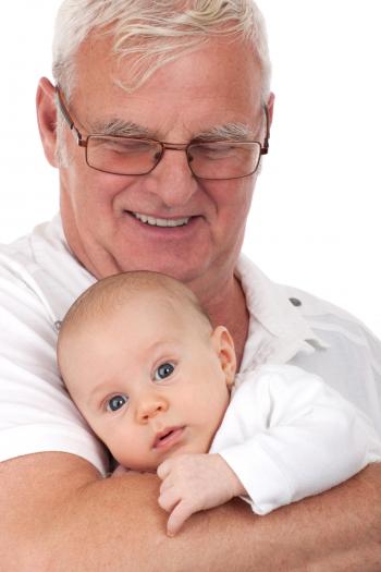 Man in Black Frame Eyeglasses Carrying a Baby