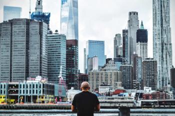 Man in Black T Shirt in Front on City Skyline during Daytime