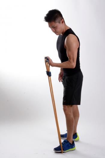 Man in Black Tank Top Holding Brown Stretching Rope