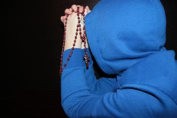 Man in Blue Praying
