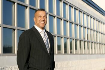 File:Man in biz suit in front of office windows.jpg - Wikimedia Commons