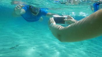 Slow motion of two people diving to get good underwater shot. Woman ...