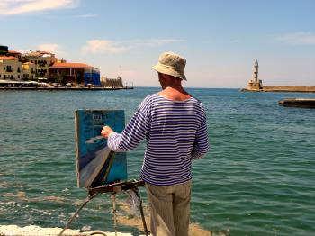 Man in White and Blue Striped Long-sleeved Shirt Painting Near Seashore
