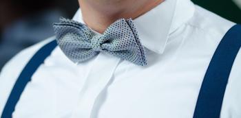 Man in White Dress Shirt Blue Suspenders and Gray Polka Dotted Bowtie