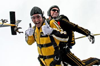 Man in Yellow Jumpsuit and Man in Black Jumpsuit Sky Diving