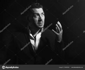handsome serious man looking up in the dark — Stock Photo © spaxiax ...