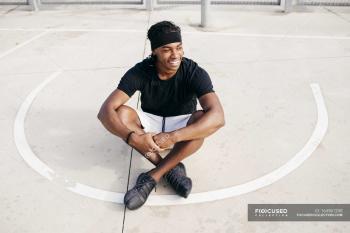 Man sitting on basketball ground — Stock Photo | #164961298