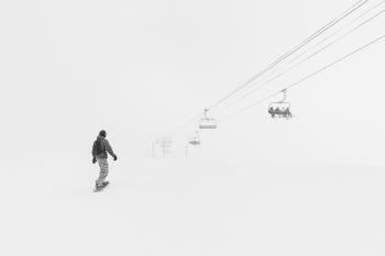Man Walking in the Snow at Daytime