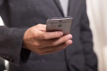Man Wearing Black Suit Jacket Holding Gray Htc Android Smartphone