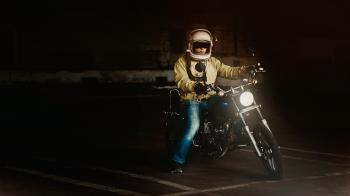 Man Wearing White Full Face Helmet Riding on Standard Motorcycle