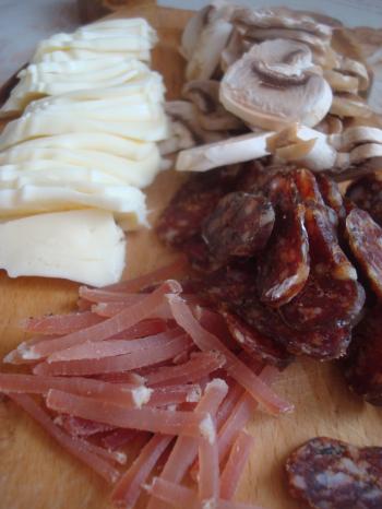 Meat, cheese and mushrooms on a plate