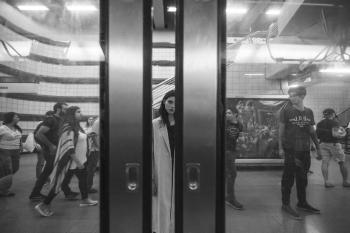 Monochrome Photography of Woman Standing at the Subway