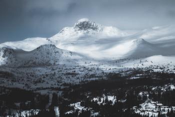 Mountain Coated With Snow Under Gray Sky