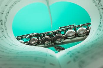 Music Note Book and Silver Soprano Flute Close Up Photography