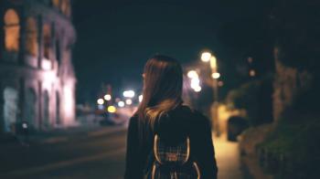 Young attractive woman walking late at night alone in Rome, Italy ...