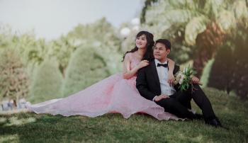 Nuptial Photo of Man in Black Formal Suit and Woman in Pink Gown
