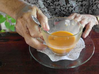 Old Lady Holds Tea Cup