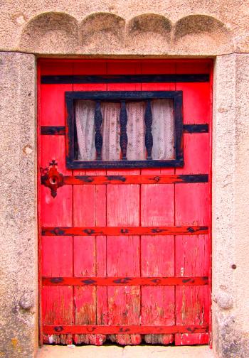 Old red door on a stone building