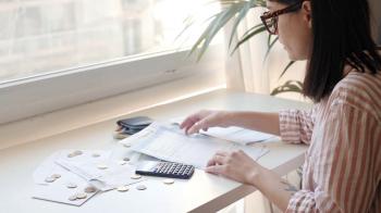 Very stressed young brunette girl in glasses checks papers with her ...
