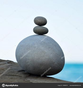 Stones pyramid on pebble beach symbolizing stability, harmony ...