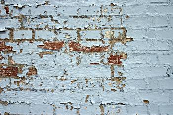 Peeled paint on a brick wall