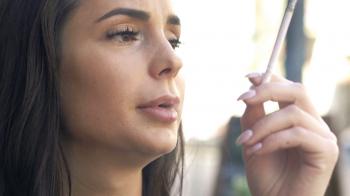 Pensive woman smoking cigarette sitting in cafe in city Stock Video ...