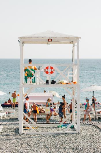 People Near Beach With Lifeguard Gazebo