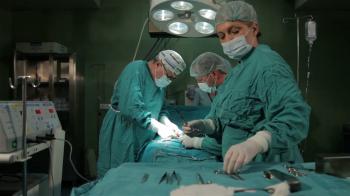 Surgeons team performing surgical operation in operating room ...