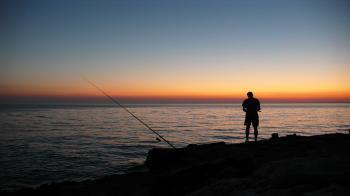 Person Fishing during Sunset