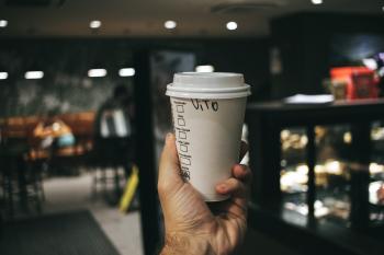 Person Holding Labeled Disposable Cup
