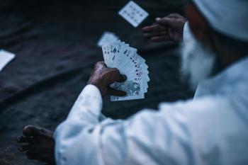 Person Holding Playing Cards