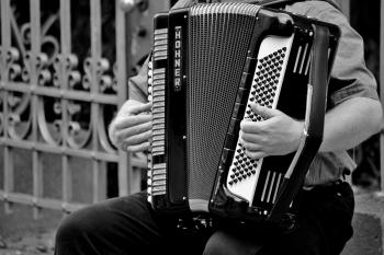 Person Playing a Horner Musical Intrument in Grayscale