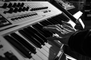 Person Playing Electric Piano in Grayscale Photo