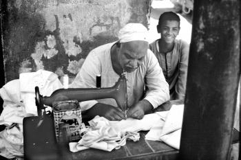 Person Sewing Cloth on Sewing Machine