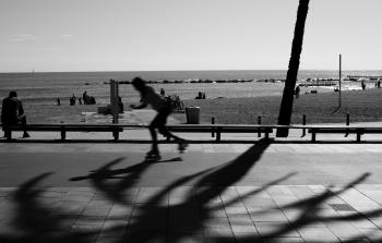Person Skating on Road in Grayscale Photography