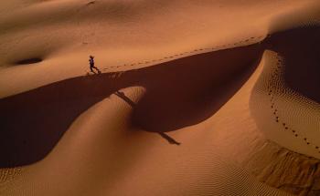 Person Walking on Desert