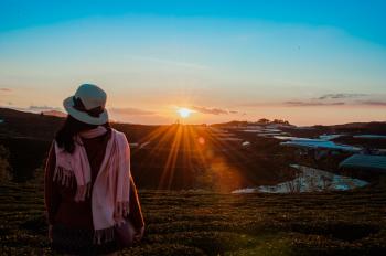 Person Wearing White Fedora Hat and Pink Scarf during Golden Hour