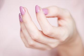Person's Hand With Pink Manicure