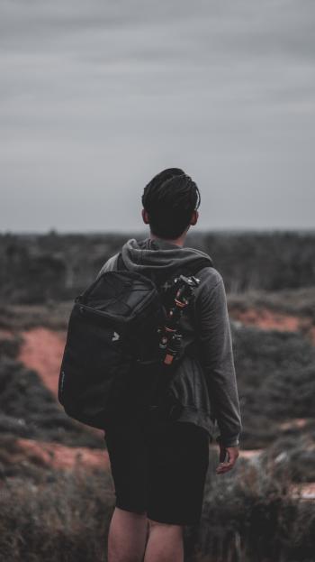 Photo of a Man Wearing Black Backpack