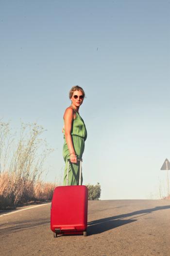 Photo of a Woman Holding her Luggae