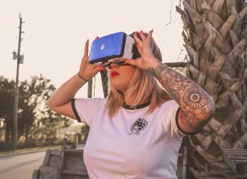 Photo of a Woman Using Virtual Reality Glasses